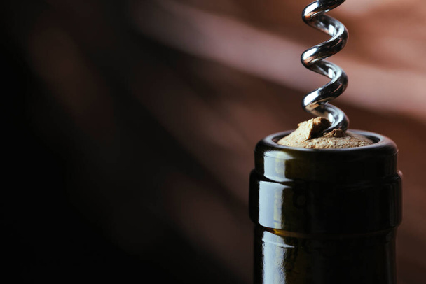 corkscrew opens a bottle of wine, close-up, accessory - Фото, изображение
