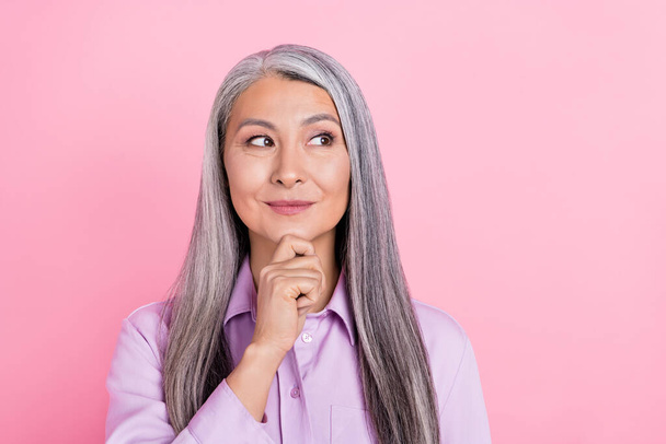 Portrait of attractive cheery curious gray-haired woman overthinking copy space isolated over pink pastel color background - Foto, imagen