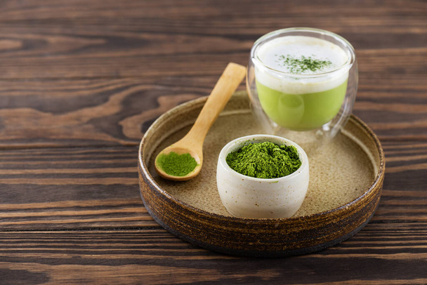 Matcha tea on a tray on a wooden table. Horizontal orientation, copy space. - Photo, Image
