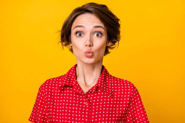 Photo of optimistic nice brunette lady blow kiss wear red shirt isolated on vivid yellow color background - Zdjęcie, obraz