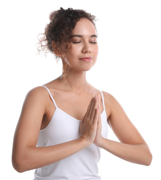 Beautiful African-American woman meditating on white background - Photo, image