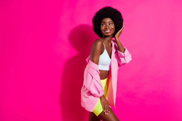 Photo of adorable cute dark skin lady wear casual shirt looking empty space arm hair smiling isolated pink color background - Fotoğraf, Görsel