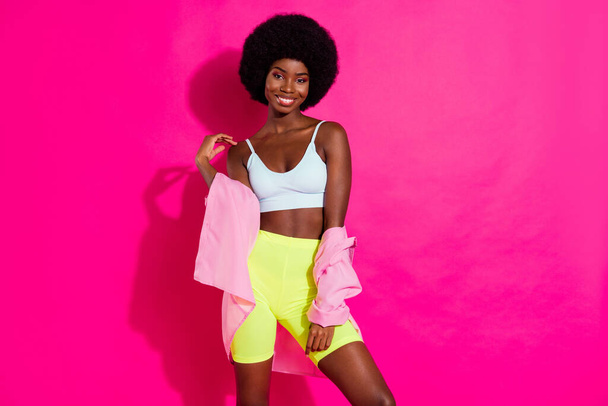 Photo of shiny adorable dark skin woman dressed crop top smiling empty space isolated pink color background - Foto, Imagen