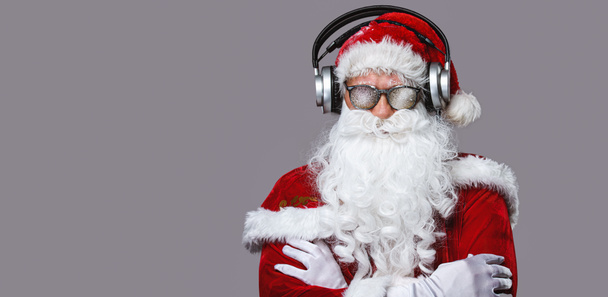 Cool Santa Claus is listening music in headphones - Fotoğraf, Görsel