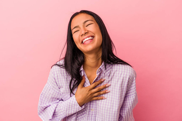 Young latin woman isolated on pink background  laughs out loudly keeping hand on chest. - Foto, immagini