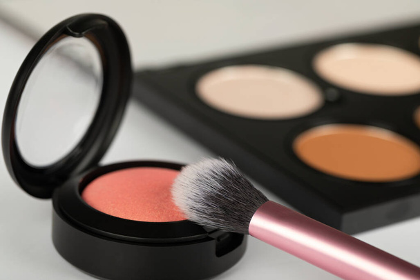 Close up picture of make up products and accessories, contour palette, brushes on white background - Foto, Bild
