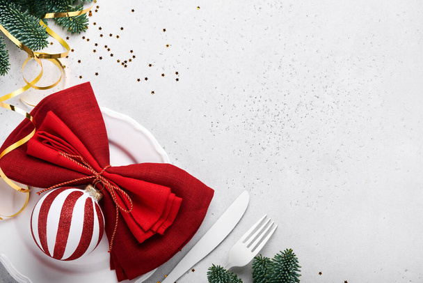 Christmas table setting white color with silverware, napkin red color, Christmas balls, champagne, glasses on white background for xmas greetings. Mock up. - Foto, Imagem