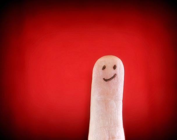 Smiling face on finger - Foto, Imagen