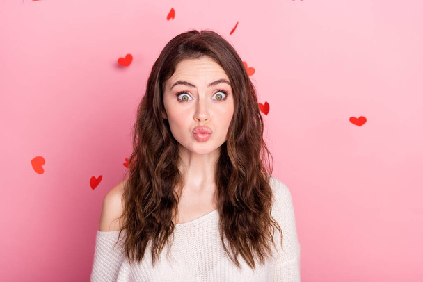 Photo of young attractive girl pouted lips send air kiss you fly air heart confetti isolated over pastel color background - Foto, afbeelding