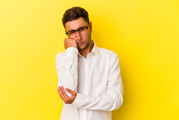 Young caucasian man with tattoos isolated on yellow background  who feels sad and pensive, looking at copy space. - Foto, imagen