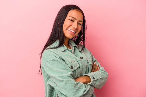 Young latin woman isolated on pink background  happy, smiling and cheerful. - Photo, Image