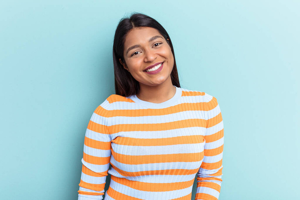 Young Venezuelan woman isolated on blue background happy, smiling and cheerful. - Φωτογραφία, εικόνα