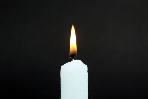Candle flame on a black background. The fire is burning. - Photo, image