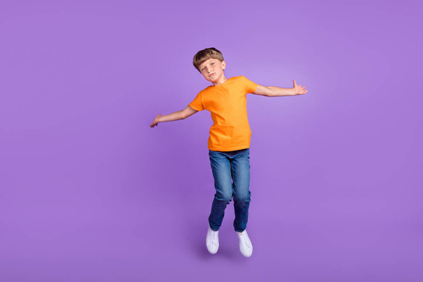 Full length body size photo boy jumping up casual clothes isolated pastel violet color background - Foto, immagini