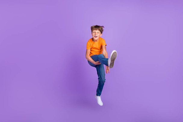 Full length body size photo boy jumping careless cheerful isolated pastel violet color background - Φωτογραφία, εικόνα