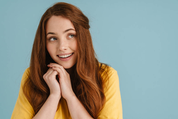 Young ginger white woman smiling and looking aside isolated over blue background - Photo, Image
