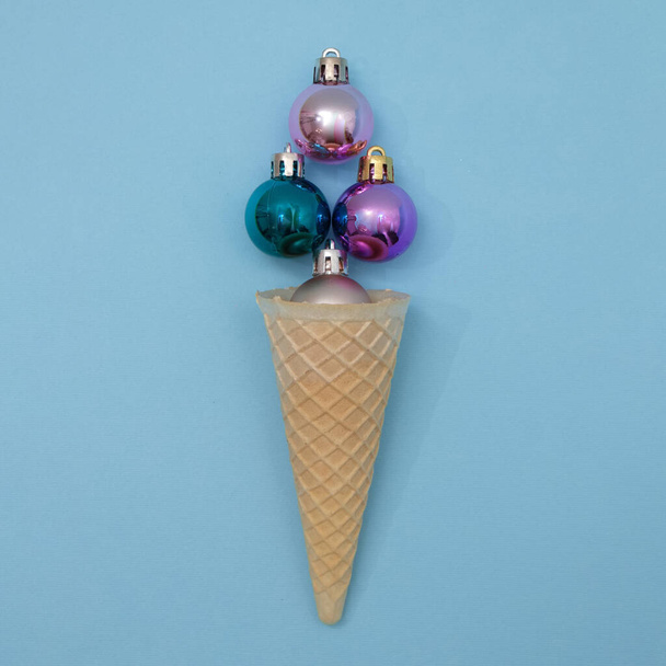Ice cream from New Year's decorations in a cone. Minimal scene, flat lay. - 写真・画像