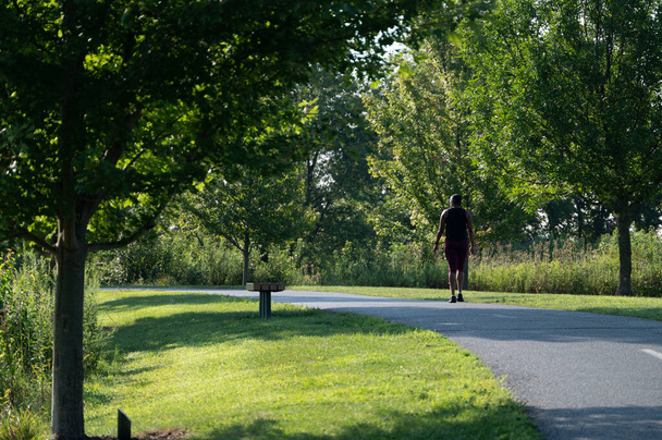 A beautiful shot of someone walking down a path - Фото, изображение