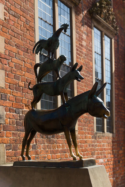 Bronze statue of the Town Musicians on Rathausplatz marktplatz or market square in historical center of medieval Hanseatic city of Bremen, Germany, July 15, 2021. - Фото, изображение