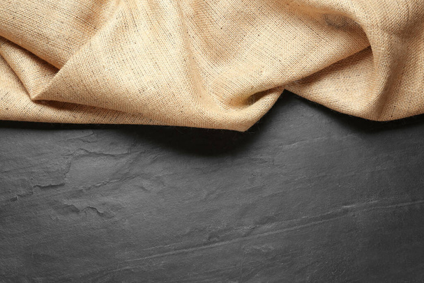 Natural burlap fabric on black table, top view. Space for text - Foto, Imagen