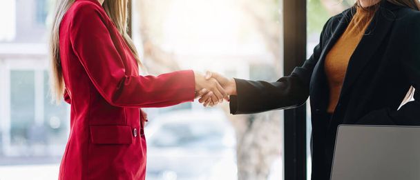 two businessman shake hands as hello in office closeup. Friend welcome, introduction, greet or thanks gesture, product advertisement, partnership approval, strike a bargain on deal concept - Photo, Image
