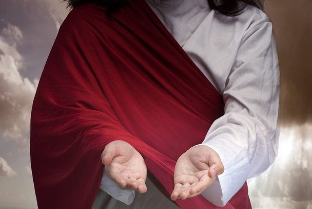 Jesus Christ with open palm giving helping hand with sunlight background - 写真・画像