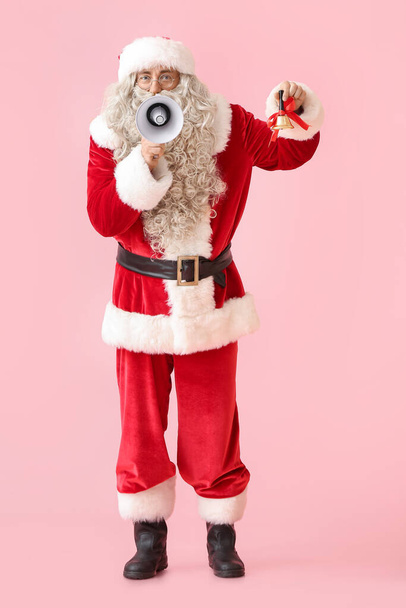 Santa Claus with megaphone and Christmas bell on pink background - Zdjęcie, obraz