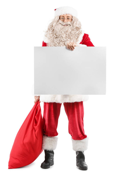 Santa Claus with bag and blank paper sheet on white background - Photo, Image