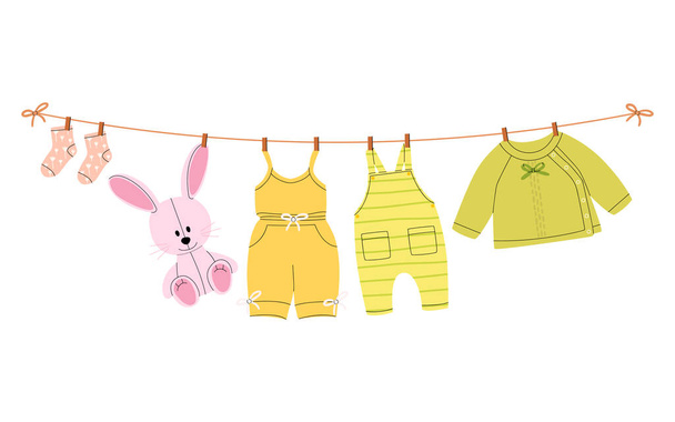 A flat vector cartoon illustration of kids things that are dried on a clothesline using clothespins. Isolated design on a white background. - Вектор,изображение
