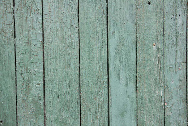 Old weathered cracked painted light green wooden rustic building wall with vertical planks - rural lifestyle background texture - Fotoğraf, Görsel