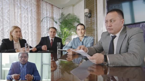 Split screen of team of businesspeople sitting at table in meeting room and discussing work with their male business partner on video call - Footage, Video