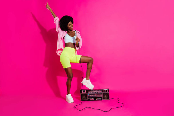 Photo of sweet adorable dark skin lady wear casual shirt standing boom box singing karaoke smiling isolated pink color background - Valokuva, kuva