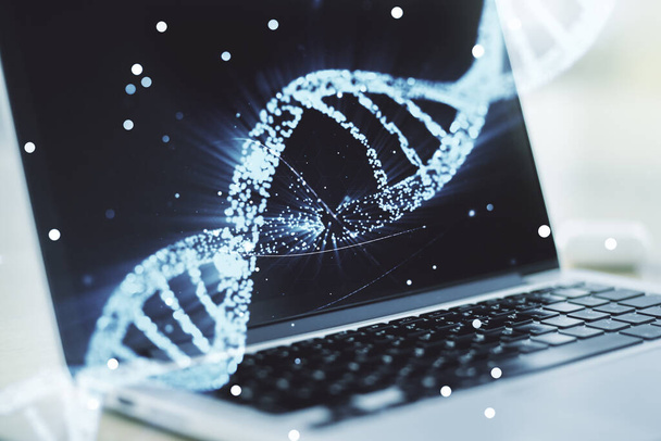 Creative DNA sketch on modern laptop background, biotechnology and genetic concept. Multiexposure - Photo, image