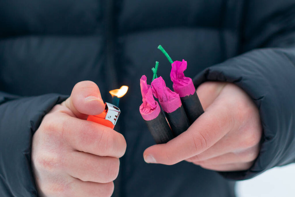 Guy Sets Fire to the Flash Noise Firecrackers Outdoors - 写真・画像