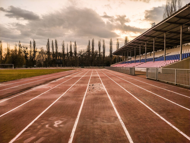 Running tracks in the stadium in the evening in winter - Photo, Image