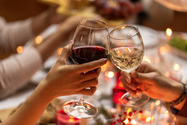 close up of hands toasting wine at christmas party - Foto, imagen