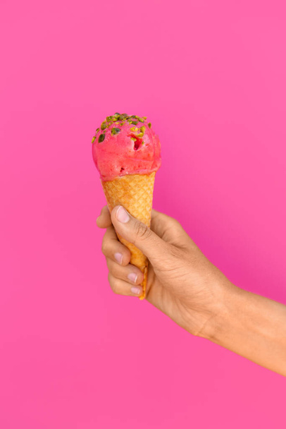 close up of hand holding waffle ice cream cone - Foto, afbeelding