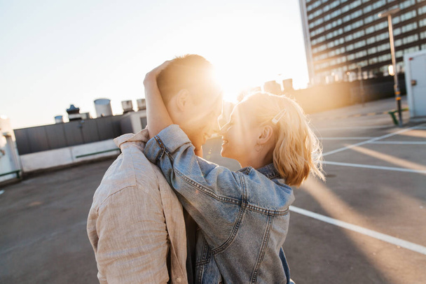 happy young couple on roof top city parking - 写真・画像
