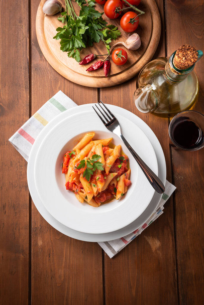 plate of delicious spicy penne all'arrabbiata, a traditional recipe of italian pasta  - Photo, Image