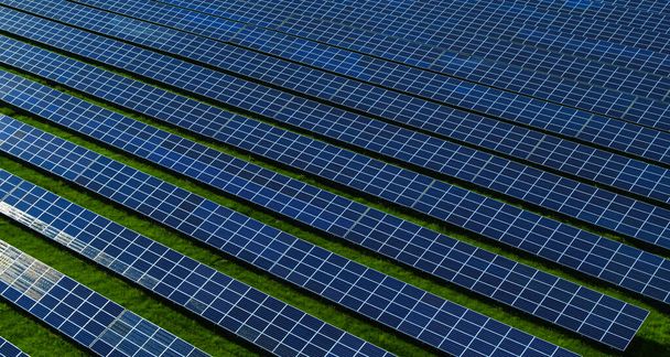 Letecký pohled fotovoltaické panely parku na zelené louce. Modrá obloha - Fotografie, Obrázek