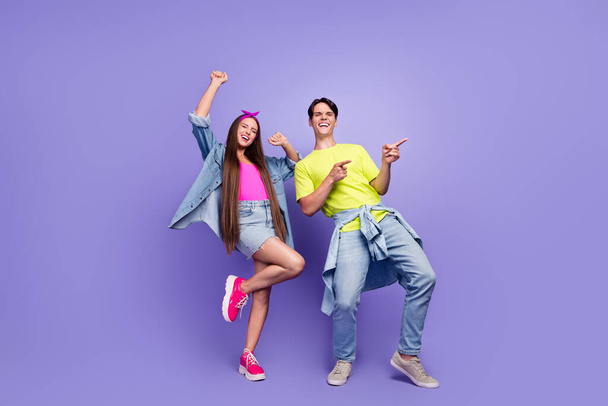 Photo of crazy couple celebrate 90s event guy direct empty space wear pin-up outfit isolated purple color background - Φωτογραφία, εικόνα