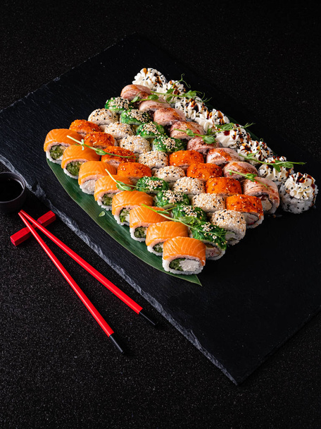 tasty sushi on the black background - Foto, Imagen