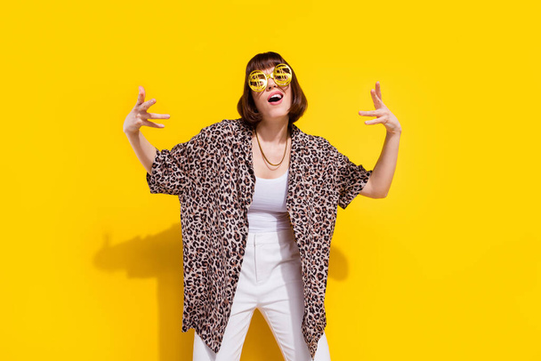 Photo of fancy young millennial lady dance wear eyewear chain leopard shirt isolated on yellow color background - Fotoğraf, Görsel