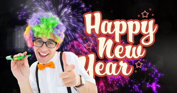 Digital composite image of smiling man gesturing and enjoying new year against firework. celebration, party and symbol. - Photo, Image