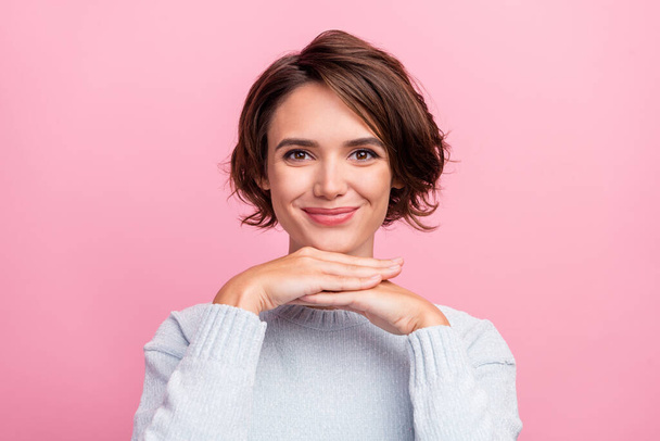 Photo of positive adorable lady hands chin look camera wear blue pullover isolated pink color background - Fotó, kép