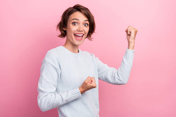 Photo of cheerful happy positive pretty young woman raise fists winner celebrate isolated on pink color background - Valokuva, kuva