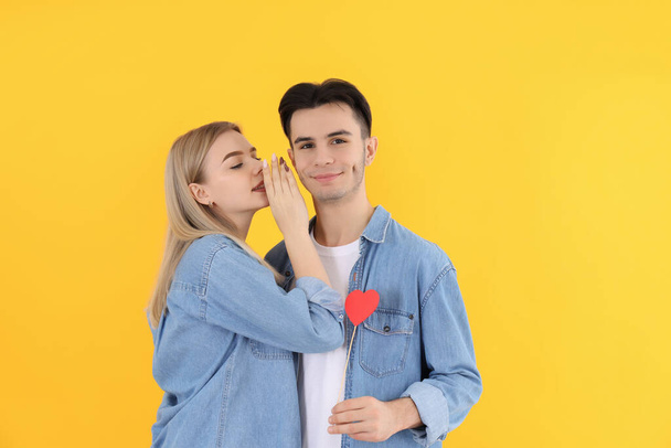 Cute couple with heart on yellow background - Fotó, kép