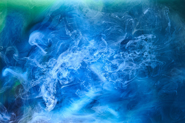 Blue green smoke on black ink background, colorful fog, abstract swirling ocean sea, acrylic paint pigment underwater - Zdjęcie, obraz