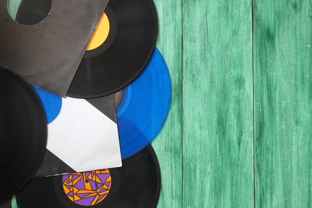 Vinyl record on a green background. Retro style. Top view. - Photo, Image