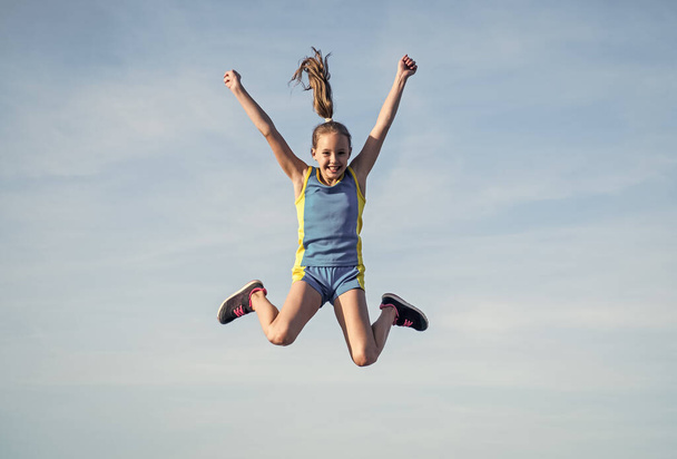 happy kid in sport training clothes jumping outdoor, happiness - Fotoğraf, Görsel
